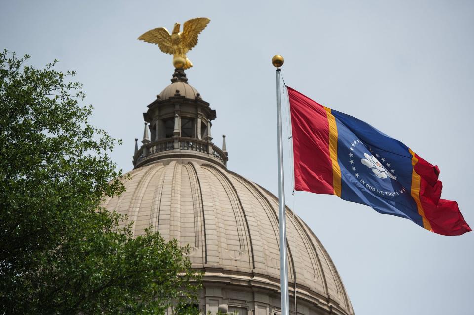 Mississippi State Capitol dome, exterior, with state flag in focus, in Jackson, Miss., photographed Thursday, July 13, 2023.