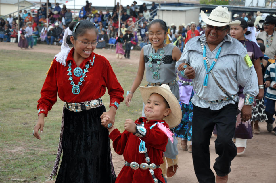 This undated image provided by the Navajo Tourism Department shows tribal members participating in the social song and dance competition during the 2011 Navajo Nation Fair in Window Rock, Ariz. An economic impact study and yearlong survey show spending by tourists on the Navajo Nation has increased by nearly one-third since 2002. (AP Photo/Navajo Tourism Department, Roberta John)