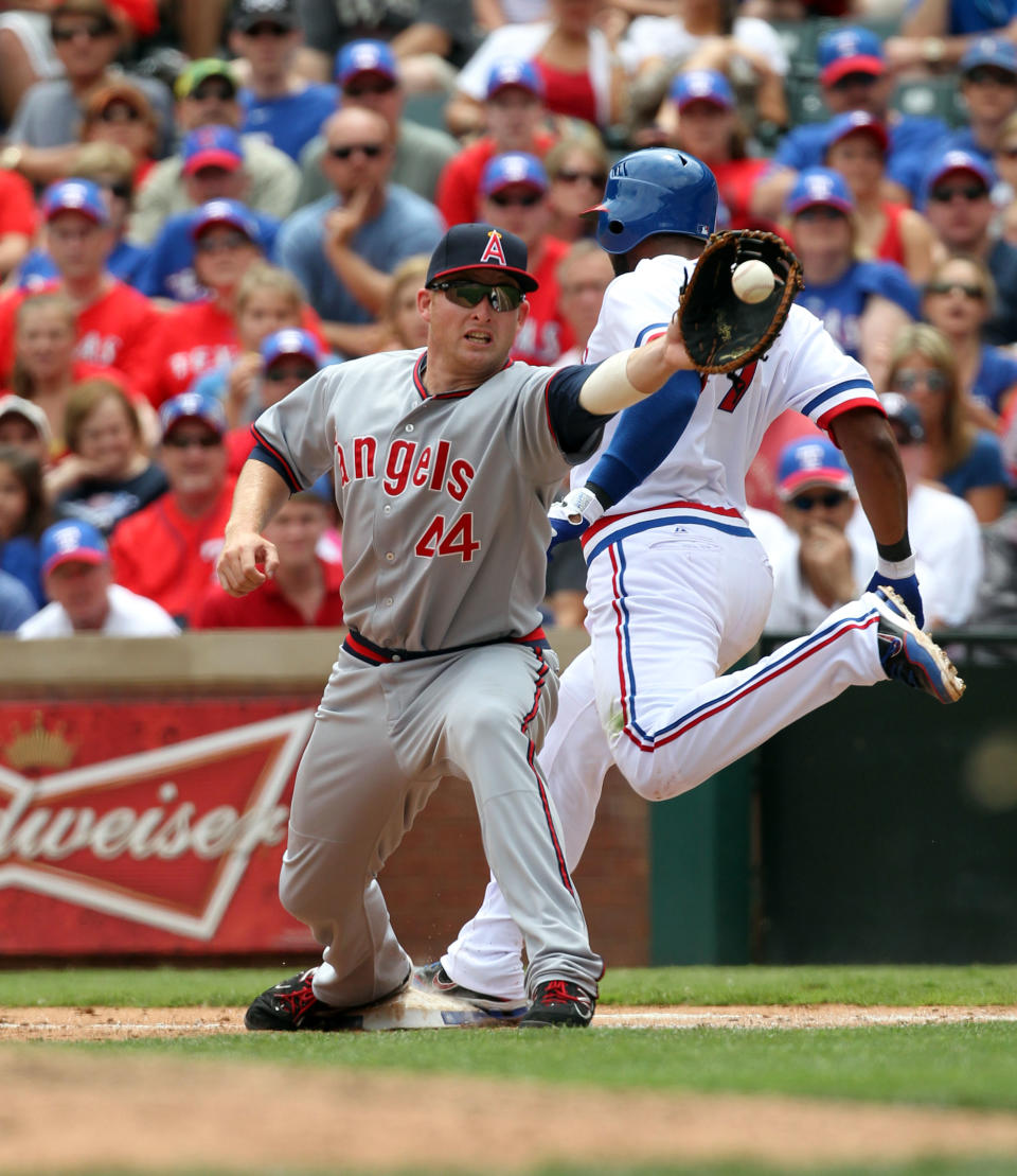 ARLINGTON, TX - MAY 12: Elvis Andrus #1 of the Texas Rangers is called out at first as 1st baseman Mark Trumbo #44 of the Los Angeles Angels of Anaheim fields the throw on May 12, 2012 in Arlington, Texas. The Angels won 4-2. (Photo by Layne Murdoch/Getty Images)