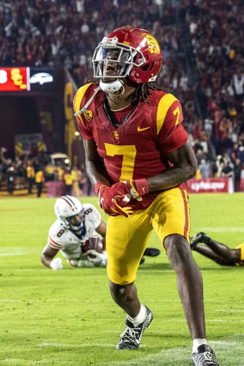 USC safety Calen Bullock celebrates immediately after the Trojans' triple-overtime win over Arizona at the Coliseum.