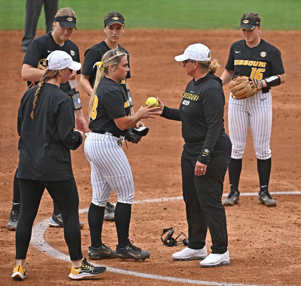 Missouri coach Larissa Anderson hands the ball over to Taylor Pannell, who came in to pitch against LSU during an NCAA college softball game Saturday, April 8, 2023, in Baton Rouge, La.