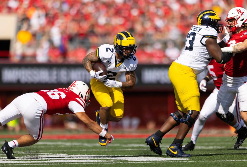 Michigan running back Blake Corum rushes against Nebraska's Koby Bretz during the first half on Saturday, Sept. 30, 2023, in Lincoln, Nebraska.