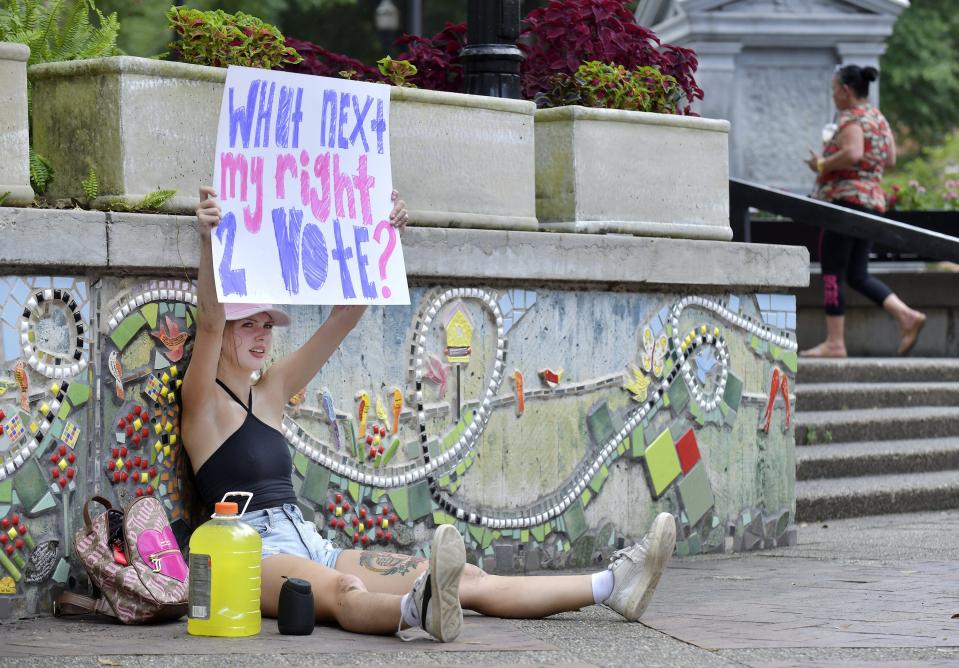 Shyanne Padgett, 20 sits in James Weldon Johnson Park with her handmade sign in reaction to the overturning of Roe vs. Wade by the Supreme Court Friday.