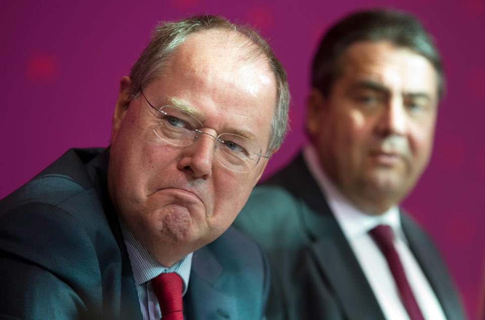 Angela Merkel's designated top challenger in the general elections Peer Steinbrueck, left, and head of the German Social Democrats, SPD, Sigmar Gabriel wait for the start of a meeting of the party's executive committee in Berlin, Germany, Monday, Oct. 1, 2012. (AP Photo/dapd, Michael Gottschalk)