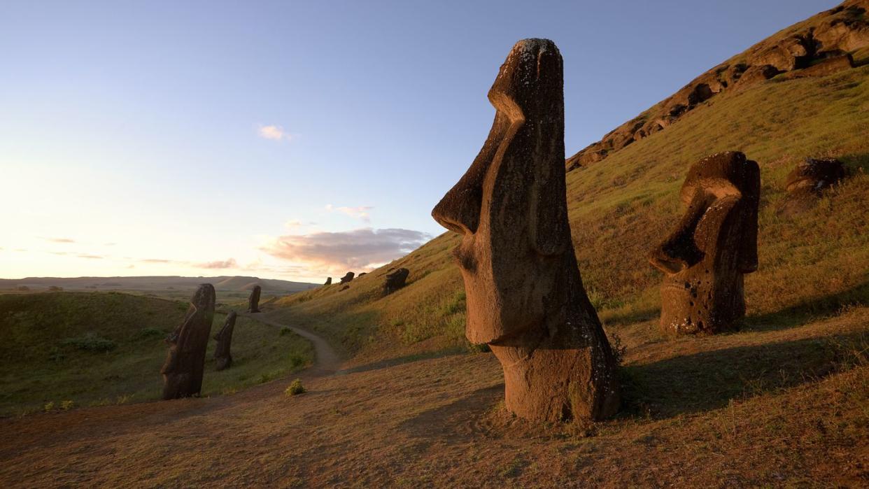 chile, easter island, moai statues of rano raraku at dusk