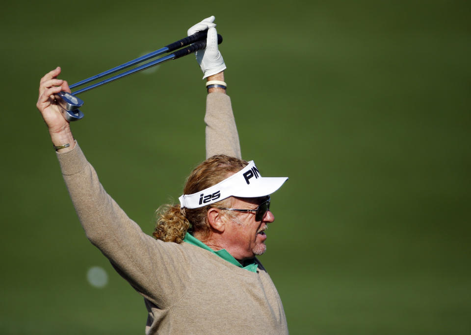 Miguel Angel Jimenez, of Spain, stretches before hitting on the driving range during a practice round for the Masters golf tournament Wednesday, April 9, 2014, in Augusta, Ga. (AP Photo/Matt Slocum)
