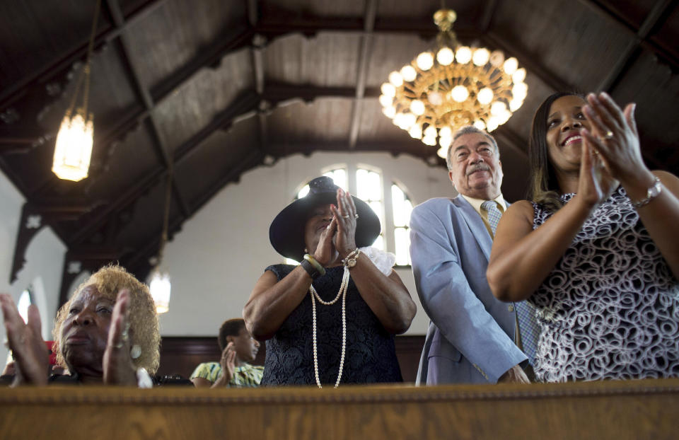 FILE - In this Sunday, July 10, 2016 file photo, parishioners clap during a worship service at the First Baptist Church, a predominantly African-American congregation, in Macon, Ga. There are two First Baptist Churches in Macon _ one black and one white. (AP Photo/Branden Camp)