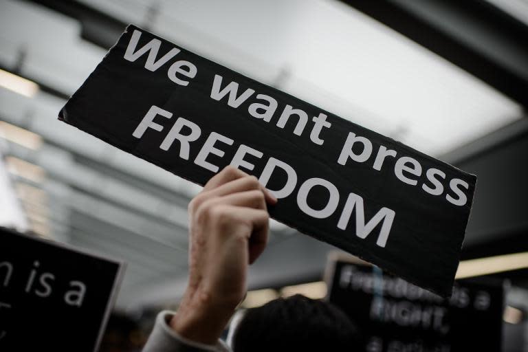 A protester takes part in a rally in support of press freedom in Hong Kong on March 2, 2014 following the attack on Kevin Lau, a former editor of liberal newspaper Ming Pao