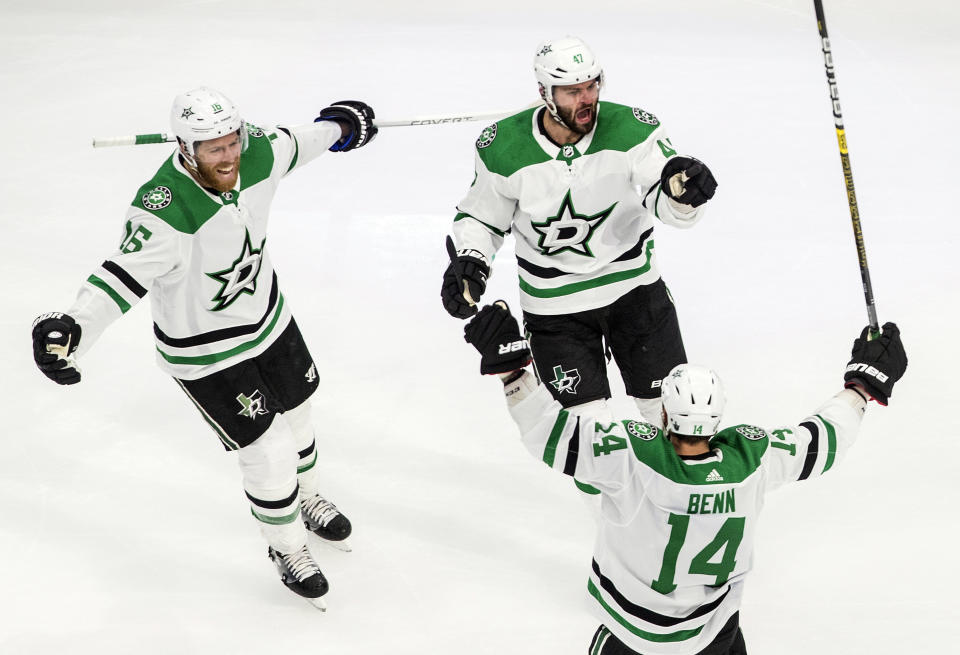 Dallas Stars' Joe Pavelski (16), Alexander Radulov (47) and Jamie Benn (14) celebrate a goal against the Colorado Avalanche during third-period NHL Western Conference Stanley Cup playoff game action in Edmonton, Alberta, Friday, Sept. 4, 2020. (Jason Franson/The Canadian Press via AP)