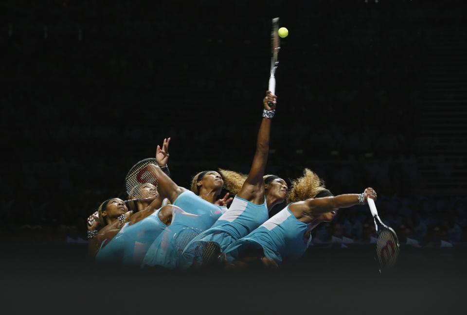 Serena Williams of the U.S. serves against Caroline Wozniacki of Denmark during their WTA Finals singles semi-final tennis match at the Singapore Indoor Stadium