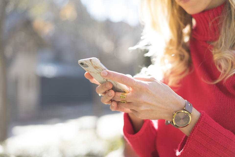 Close-up of woman using smartphone in a garden