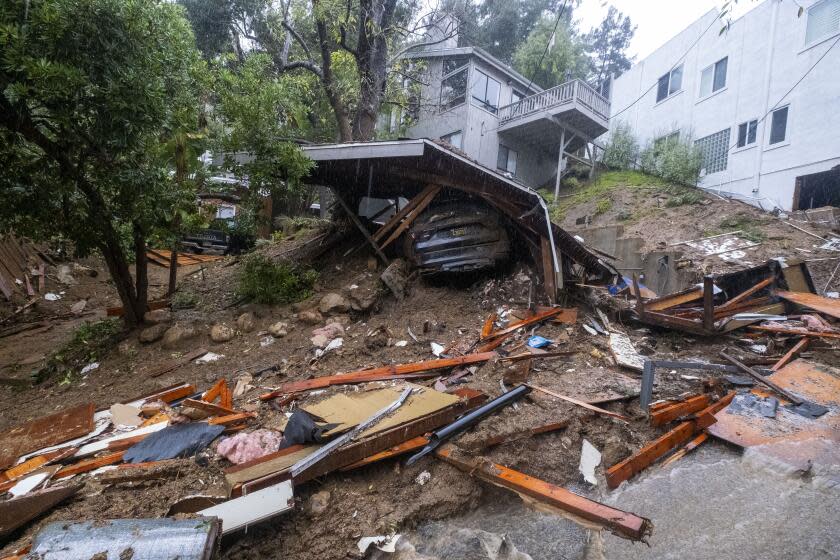 A home is damaged by a storm is seen on Caribou Ln during a rainstorm in the Beverly Crest neighborhood