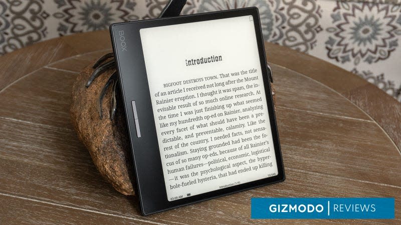 The Onyx Boox Leaf 2 sitting on a wooden table with an ebook displayed on screen.