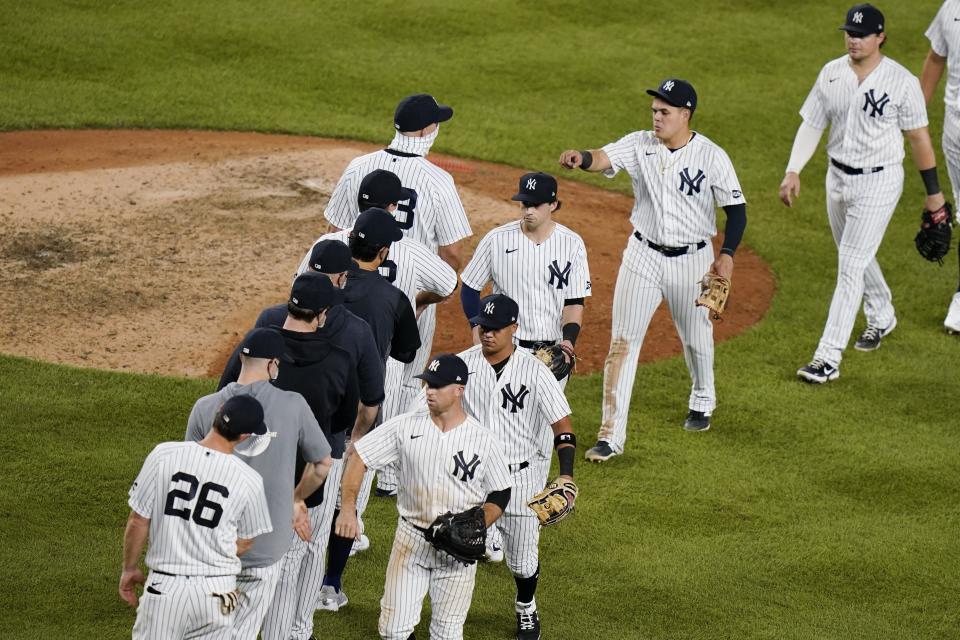 The New York Yankees celebrate after a baseball game against the Boston Red Sox Friday, Aug. 14, 2020, in New York. The Yankees won 14-7. (AP Photo/Frank Franklin II)