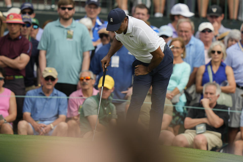 Tiger Woods holds his leg on the first hole during the first round of the Masters golf tournament at Augusta National Golf Club on Thursday, April 6, 2023, in Augusta, Ga. (AP Photo/Charlie Riedel)