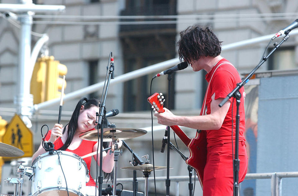 Meg and Jack White of The White Stripes performing onstage.