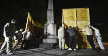 <p>Birmingham city workers use plywood panels to cover the Confederate Monument in Linn Park, in Birmingham, Ala., Aug. 15, 2017, on orders from Mayor William Bell. (Photo: Joe Songer/AL.com via AP) </p>