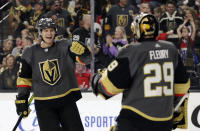 Vegas Golden Knights defenseman Nick Holden, Right, celebrates with goalie Marc-Andre Fleury after scoring against the Washington Capitals during the first period of an NHL hockey game Monday, Feb. 17, 2020, in Las Vegas. (AP Photo/Isaac Brekken)