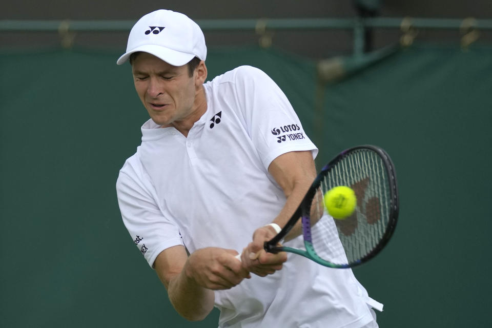 Poland's Hubert Hurkacz returns the ball to Spain's Alejandro Davidovich Fokina during their men's singles tennis match on day one of the Wimbledon tennis championships in London, Monday, June 27, 2022. (AP Photo/Alastair Grant)