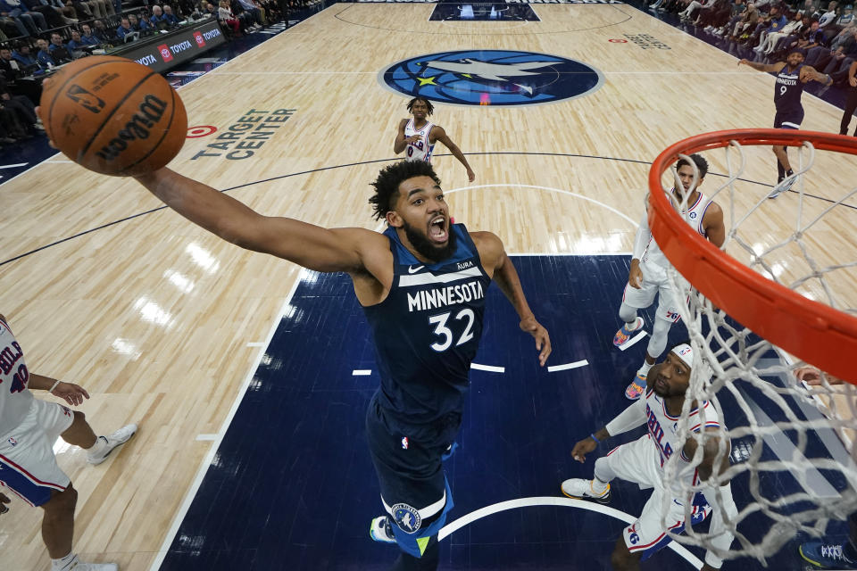 Minnesota Timberwolves center Karl-Anthony Towns (32) goes up for a dunk against the Philadelphia 76ers during the second half of an NBA basketball game Wednesday, Nov. 22, 2023, in Minneapolis. (AP Photo/Abbie Parr)