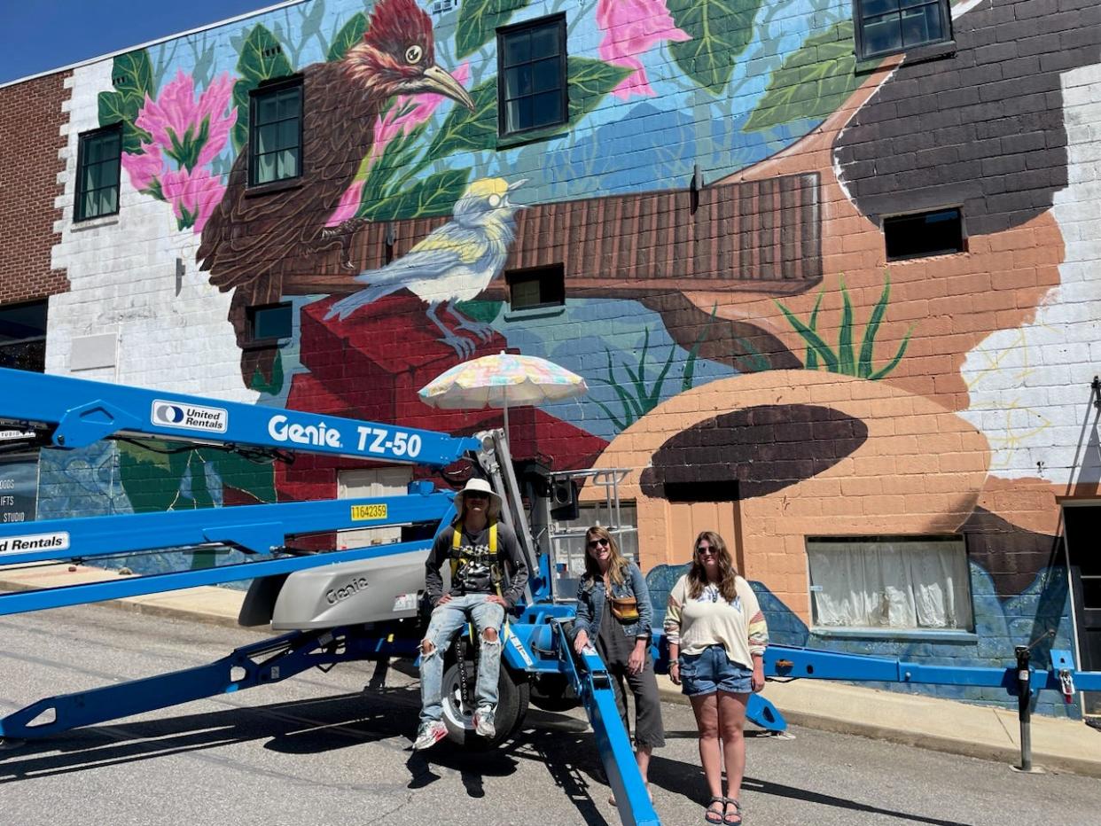 Pictured from left are mural artist Gabe Eng-Goetz, Mars Hill University art therapy professor Kelly Spencer and Mars Hill University student Grace Keaser, who is one of six apprentices for the mural project.
