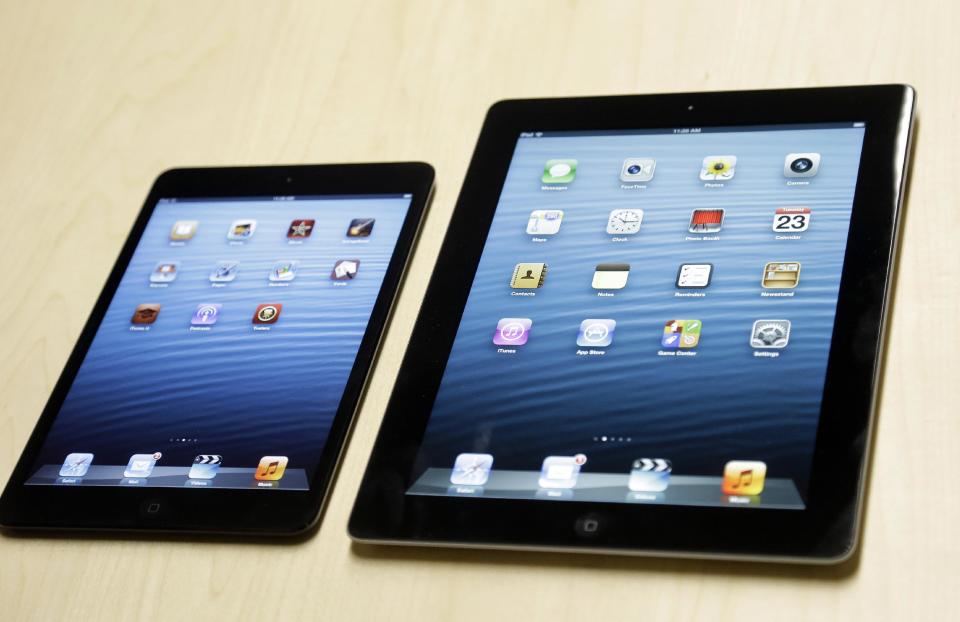 The iPad mini, at left, is shown next to the 4th generation iPad in San Jose, Calif., Tuesday, Oct. 23, 2012. The device has a screen that's about two-thirds the size of the full-size model, and Apple says it will cost $329 and up. (AP Photo/Marcio Jose Sanchez)