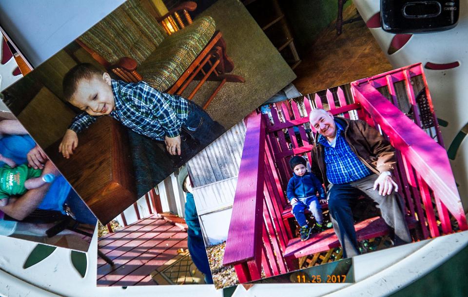 Mary Craft's photos of her great-grandson Tyler are splayed on a table at the Craft home in Gosport on Tuesday, July 11, 2023. The top photo shows Tyler learning to walk at the home. At the bottom, Oliver Craft smiles as he sits with Tyler.