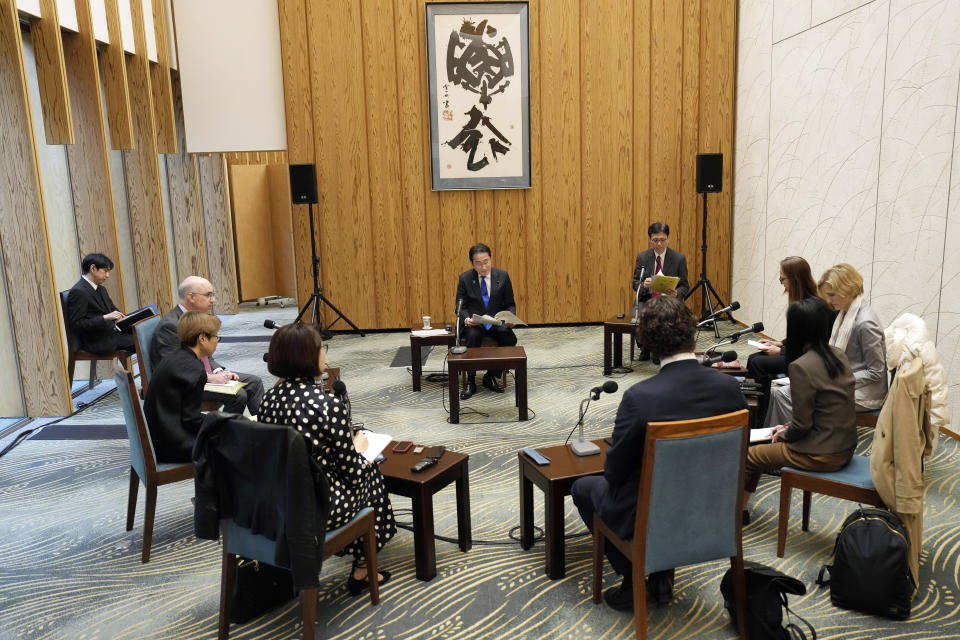 Japan's Prime Minister Fumio Kishida, center, speaks during an interview with foreign media members ahead of an official visit to the United States at the Prime Minister's official residence Friday, April 5, 2024, in Tokyo. (AP Photo/Eugene Hoshiko)