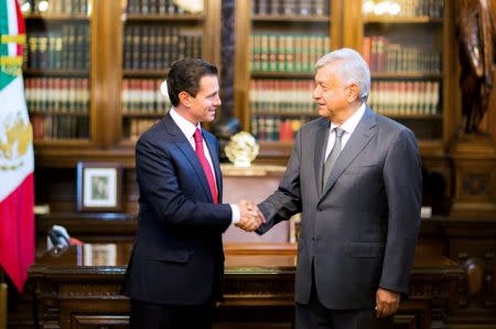 Mexico's President Enrique Pena Nieto and Mexico's president-elect Andres Manuel Lopez Obrador shake hands during a meeting at National Palace in Mexico City, Mexico in this handout photograph released to Reuters by the Mexico Presidency, July 3, 2018. Mexico Presidency/Handout via REUTERS