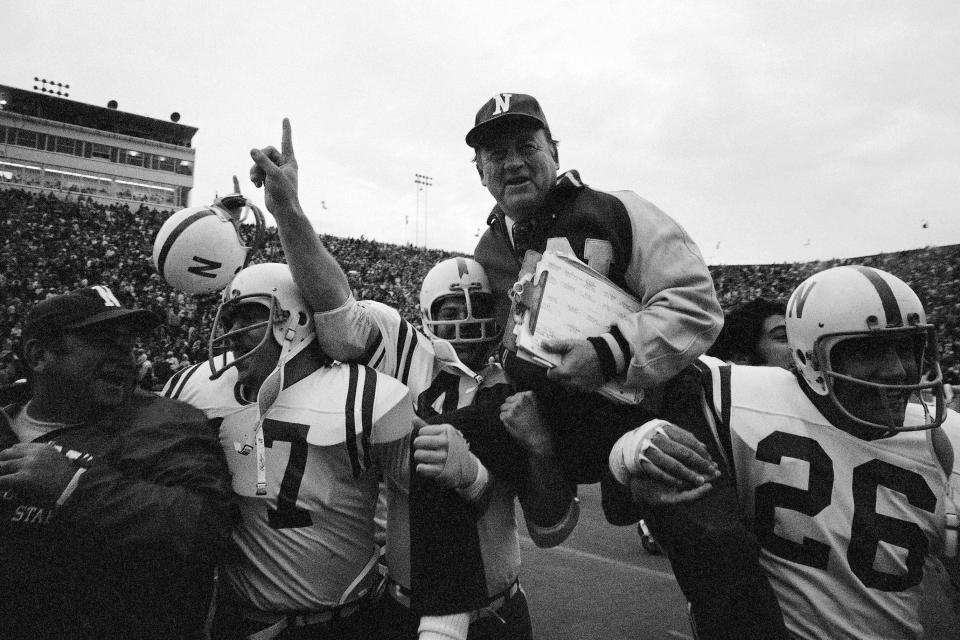 Nebraska coach Bob Devaney is carried off the field by his players after they defeated Oklahoma 35-31 in 1971.