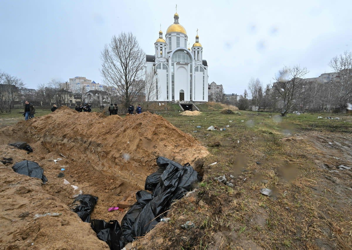 A mass grave is seen behind a church in the town of Bucha outside Kyiv (AFP/Getty)