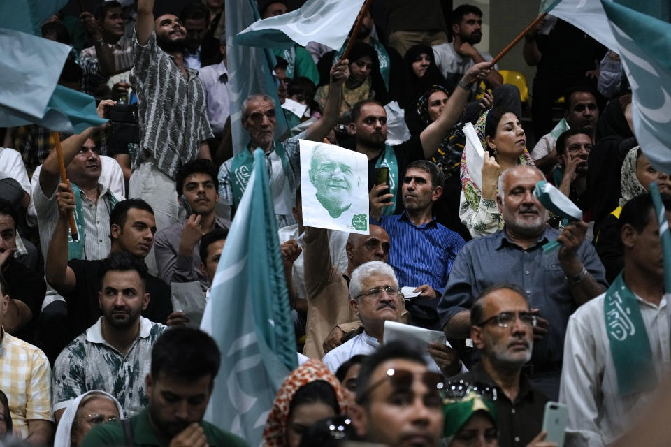 Supporters of reformist candidate for Iran's presidential election Masoud Pezeshkian attend his campaign meeting in Tehran, Iran, Sunday, June 23, 2024. (AP Photo/Vahid Salemi)