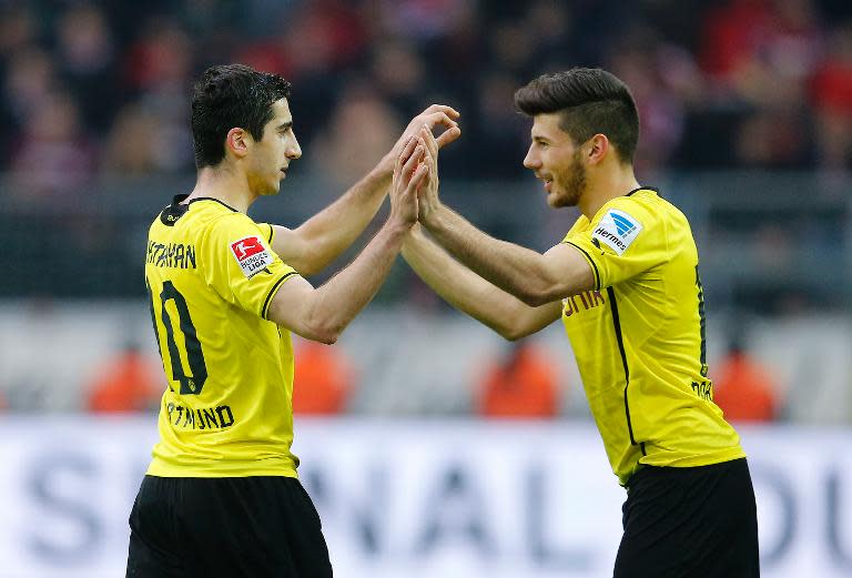 Dortmund's midfielder Milos Jojic (R) comes on for Dortmund's midfielder Henrikh Mkhitaryan during a German first division Bundesliga football match against Nuernberg in Dortmund, western Germany, on March 1, 2014