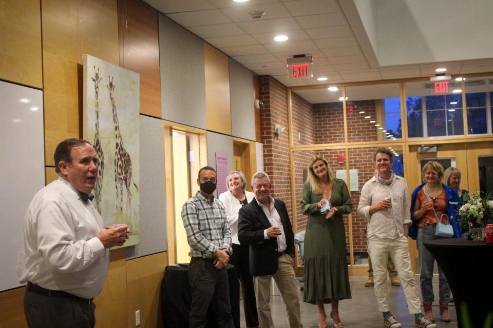 Nichols President Glenn Sulmasy addresses attendees at the opening of the artist showcase in September. Guests included, from far right, artists Pola Esther and Brian Keith Stevens, and Marla Sulmasy.