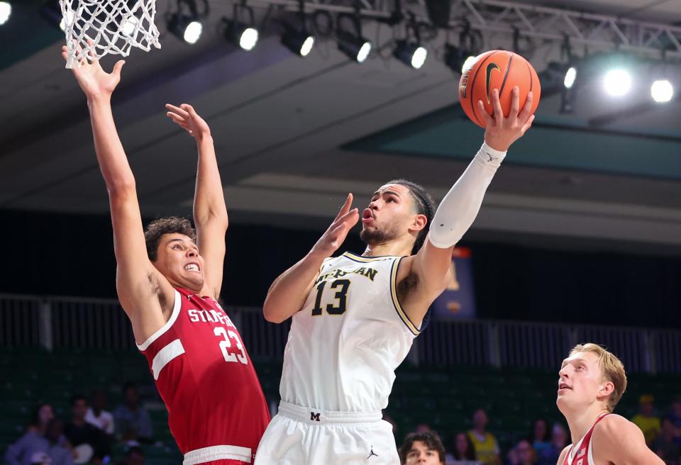 Michigan Wolverines forward Olivier Nkamhoua (13) shoots as Stanford Cardinal forward Brandon Angel (23) defends during the first half at Imperial Arena on Paradise Island, Bahamas, on Thursday, Nov. 23, 2023.