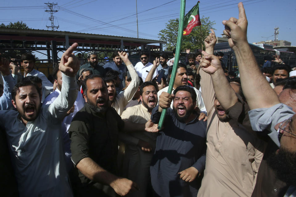 Supporters of Pakistan's former Prime Minister Imran Khan chant slogans as they block a road as a protest to condemn the arrest of their leader, in Peshawar, Pakistan, Tuesday, May 9, 2023. Pakistan's anti-graft agents on Tuesday arrested former Prime Minister Khan as he appeared in a court in the capital, Islamabad, to face charges in multiple graft cases, police and officials from his party said. (AP Photo/Muhammad Sajjad)