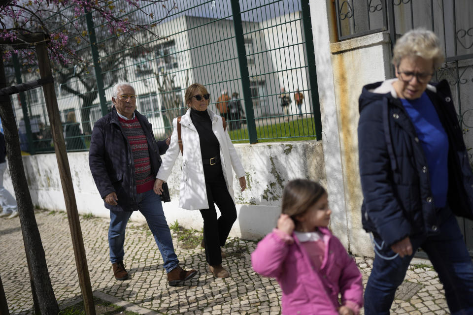 Portuguese caretaker Prime Minister Antonio Costa walks with her wife Fernanda Maria after casting their ballots at a polling station in Lisbon, Sunday, March 10, 2024. Portugal is holding an early general election on Sunday when 10.8 million registered voters elect 230 lawmakers to the National Assembly, the country's Parliament. (AP Photo/Armando Franca)