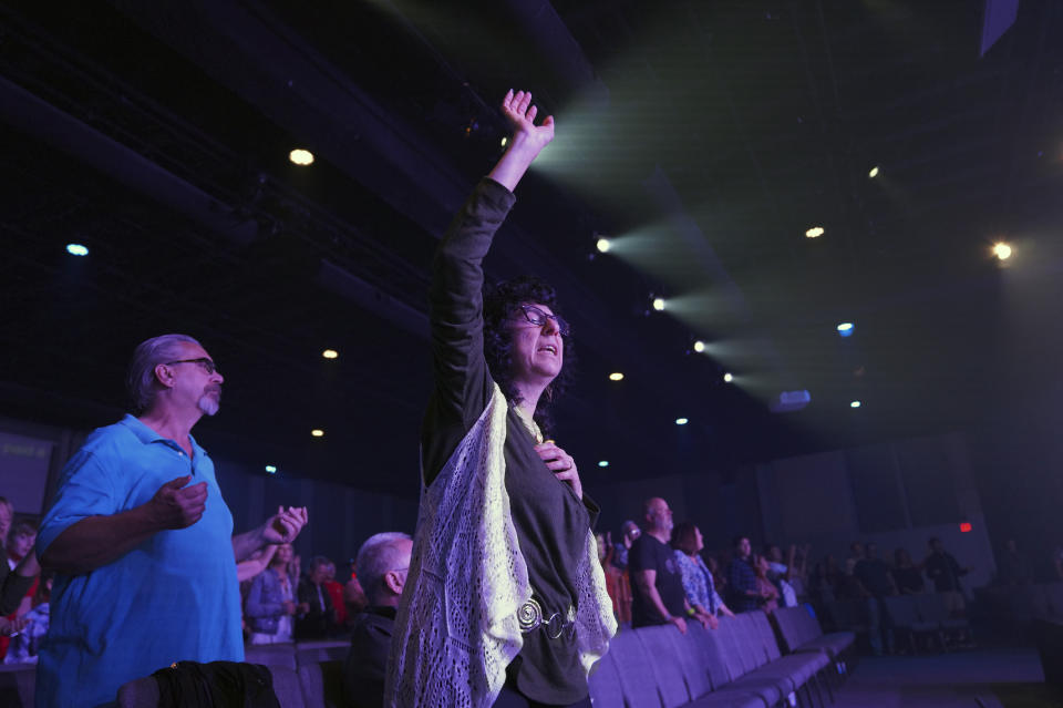 Parishioner Judy Perella raises her hand in worship during service at Allison Park Church on Sunday, Nov. 6, 2022, in Allison Park, Pa. (AP Photo/Jessie Wardarski)