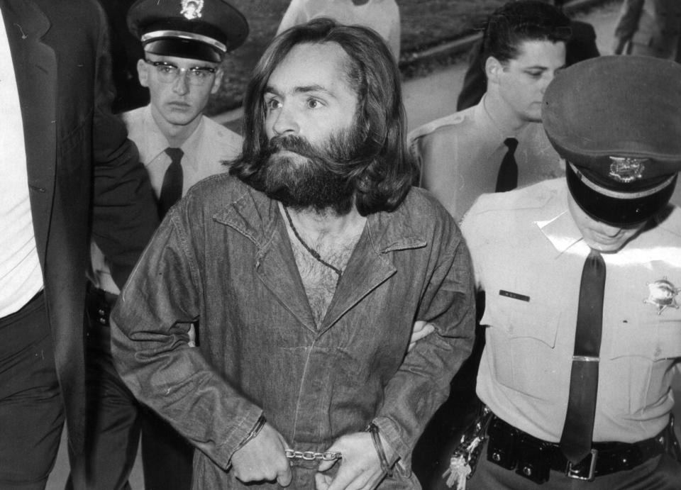 Charles Manson is escorted to court for preliminary hearing on December 3, 1969 in Los Angeles, California. (Photo by John Malmin/Los Angeles Times via Getty Images)