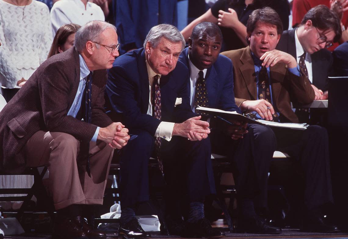 The UNC coaching staff during a game in the 1996-97 season. From left: assistant coach Bill Guthridge, head coach Dean Smith, assistant coach Phil Ford, and assistant coach Dave Hanners.