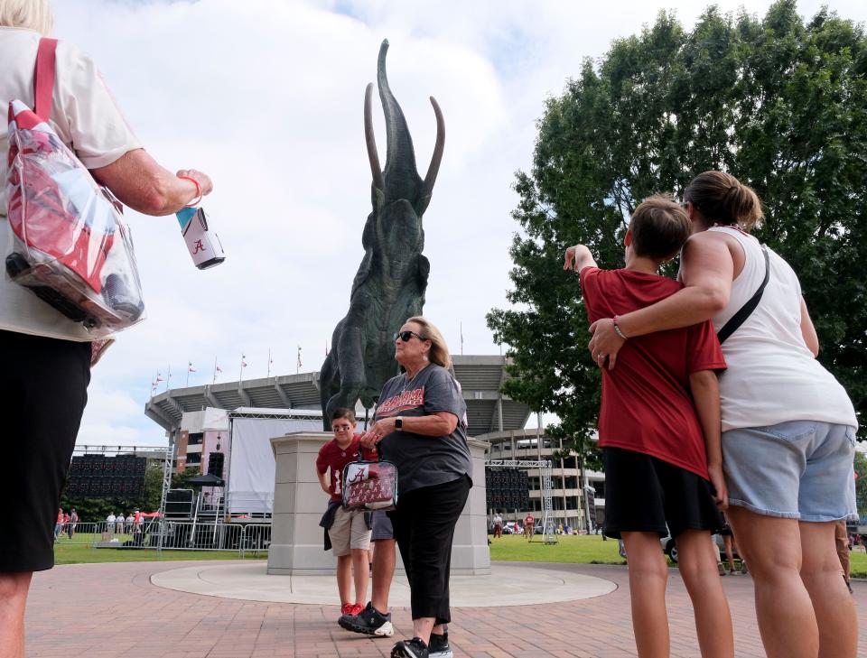 Tuska looms over fans who wait to take photos outside Bryant-Denny Stadium before Alabama faced Middle Tennessee State to open the season, Sept. 2, 2023.