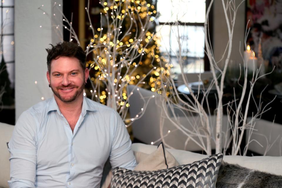 Jeff Ketterhagen relaxes with lit-up birch trees at his apartment in Milwaukee's Martin Drive area.  He's head of visuals at Luce Lighting & Luxuries, and he's in the same apartment building as the business owner, Mitchell Conklin,
