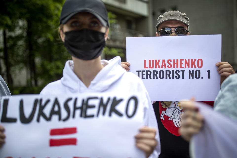 FILE - In this Friday, May 28, 2021 file photo, protesters hold banners during a demonstration demanding freedom for Belarus opposition activist Raman Protasevich, in front of the U.S. Embassy in Vilnius, Lithuania. The coronavirus pandemic has upended life around the globe, but it has hasn’t stopped the spread of authoritarianism and extremism. Some researchers believe it may even have accelerated it, but curbing individual freedoms and boosting the reach of the state. Since COVID-19 hit, Hungary has banned children from being told about homosexuality. China shut Hong Kong’s last pro-democracy newspaper. Brazil’s president has extolled dictatorship. Belarus has hijacked a passenger plane. A Cambodian human rights lawyer calls the pandemic “a dictator's dream opportunity.” But there are also resistance movements, as protesters from Hungary to Brazil take to the streets to defend democracy. (AP Photo/Mindaugas Kulbis, File)