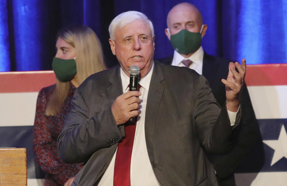 FILE - In this Nov. 3, 2020, file photo, West Virginia Gov. Jim Justice celebrates his reelection at The Greenbrier Resort in White Sulphur Springs, W.Va. A federal judge on Wednesday, July 21, 2021, blocked West Virginia from enforcing a new ban on transgender athletes. The law, signed by Justice in April, would prohibit transgender athletes from competing in female sports in middle and high schools and colleges. (AP Photo/Chris Jackson, File)