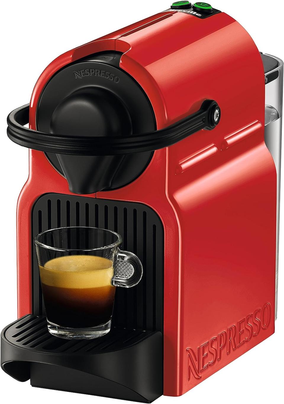 the nespresso machine with a cup of coffee on it