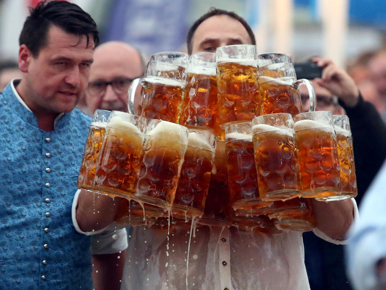 German Oliver Struempfel competes to set a new world record in carrying one liter beer mugs over a distance of 40 m (131 ft 3 in) in Abensberg, Germany September 3, 2017. Struempfel carried 29 mugs over 40 meters to set a new world record. REUTERS/Michael Dalder     TPX IMAGES OF THE DAY