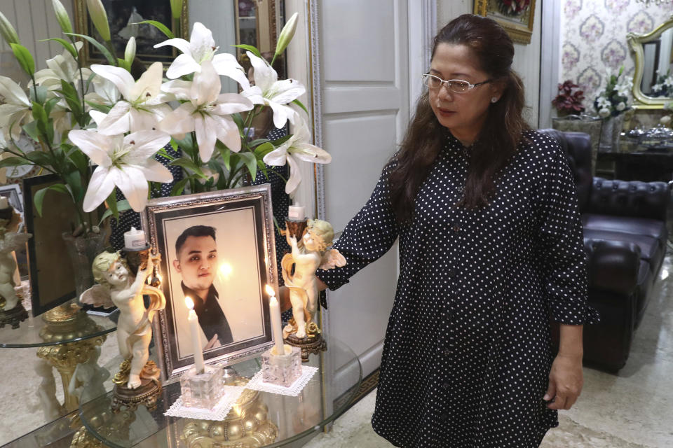 Herlina Simbala looks at a portrait of her son, Dr. Michael Robert Marampe during an online memorial service to mark the 40th day since Marampe passed away due to COVID-19 in Jakarta, Indonesia, on June 5, 2020. Marampe knew what he wanted to be since he was a kid: a doctor and a pianist. He became both, and his passion for music even led him to Tri Novia Septiani - a woman he never got to marry because he got the coronavirus. Marampe became one of dozens of doctors the coronavirus has claimed so far in Indonesia. (AP Photo/Tatan Syuflana)