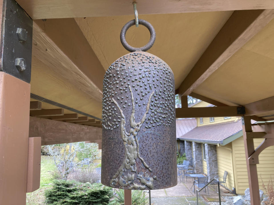 A bell hangs at the entrance to a psilocybin facilitator training venue near Damascus, Ore., on Dec. 2, 2022. People are being trained in how to accompany patients tripping on psilocybin as Oregon prepares to become the first state in America to offer controlled use of the psychedelic mushroom to the public. (AP Photo/Andrew Selsky)