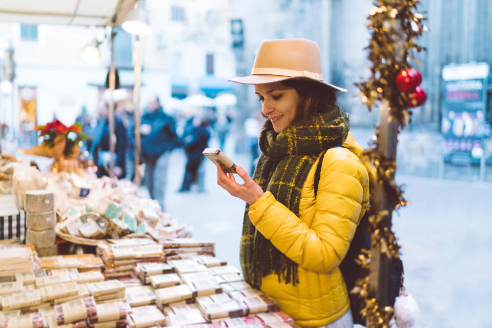 Tourist woman at street market choosing chocolate