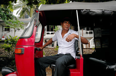 U.K Prasanna 54, waits for tourists inside his three-wheeler near a luxury hotel in Bentota, Sri Lanka May 2, 2019. REUTERS/Dinuka Liyanawatte